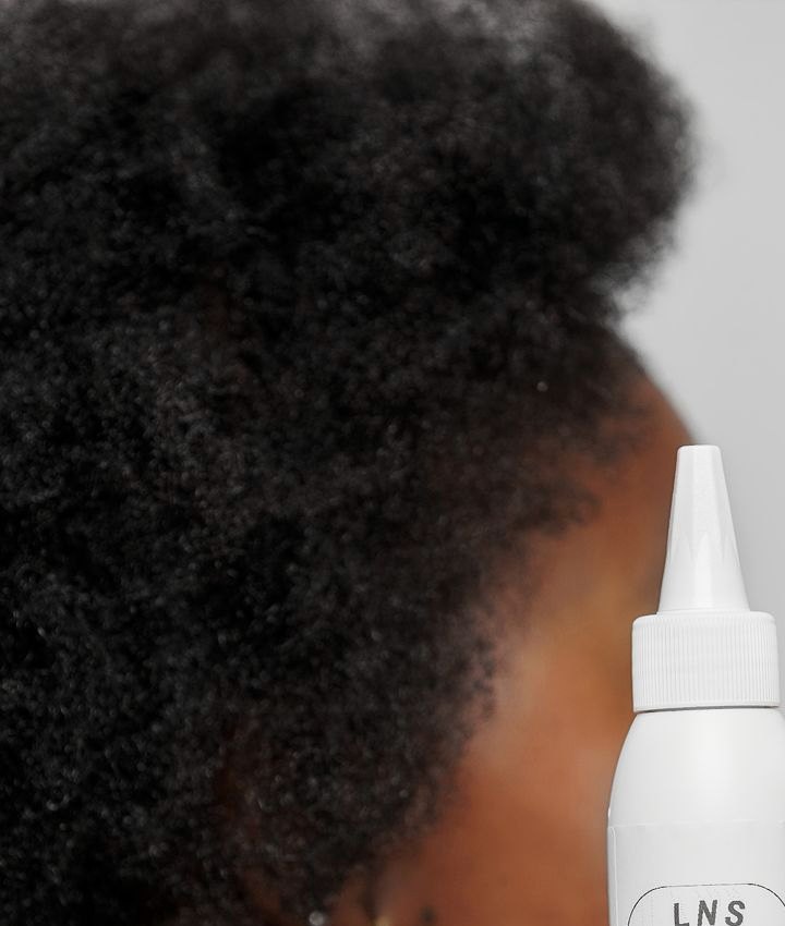 Natural hair texture and LNS Hair Growth Oil bottle